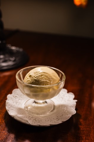 Ice cream in a glass bowl on a doily