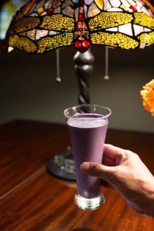 Purple ube shake with dragonfly lamp in background